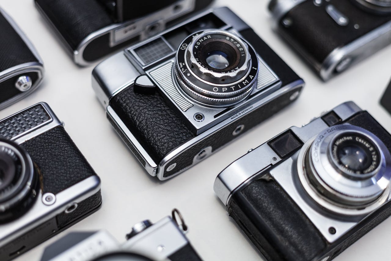 Top view of vintage cameras showcasing classic photographic design and optical lenses.